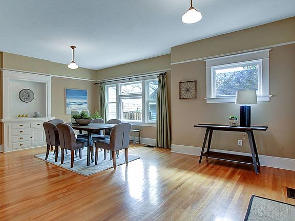 Bright, open dining room with beautiful hardwood floors and