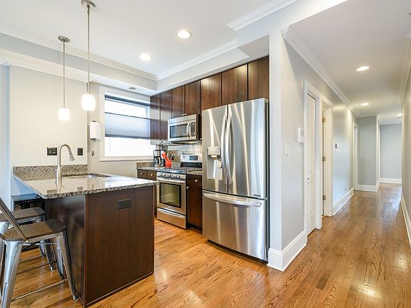 Granite breakfast bar and stainless steel appliances..a new cool refrigerator..with many bells and w