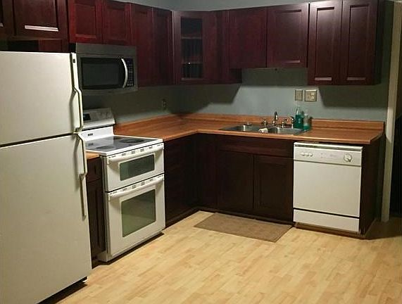 Gorgeous cherry cabinets, dishwasher, glass top range with two separate ovens, built in stainless microwave and refrigerator.