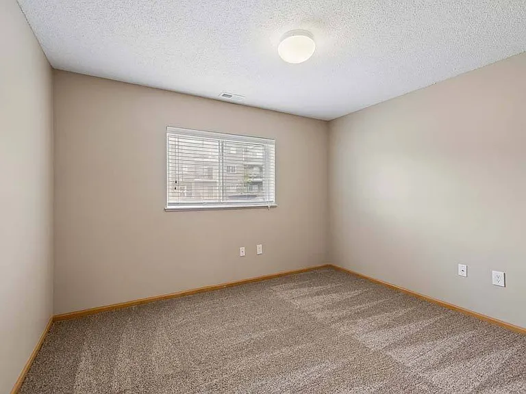Bright and inviting, this versatile bedroom offers a comfortable space to relax and make your own.