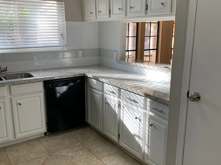 Another view of kitchen. Pass thru window to large living area