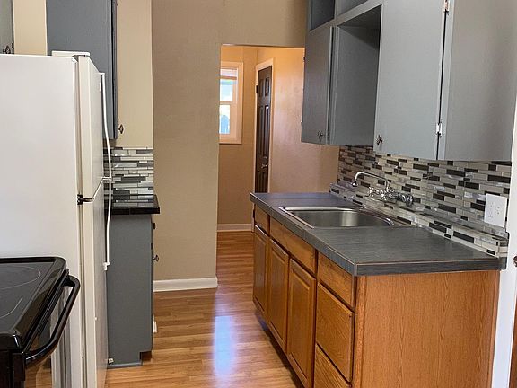 Tiled counters and backsplash newer appliances and water resistant laminate wood floor