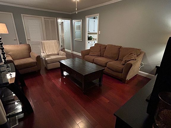 Front living room, accessible from the front door. Leads directly into the kitchen and a hallway off to the left which is home to two bedrooms and one full bath. Two storage closets located in this living space at the front of the home.
