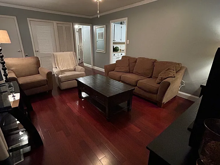 Front living room, accessible from the front door. Leads directly into the kitchen and a hallway off to the left which is home to two bedrooms and one full bath. Two storage closets located in this living space at the front of the home.