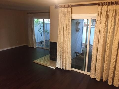 Living room/dining room showing fireplace and sliding glass 