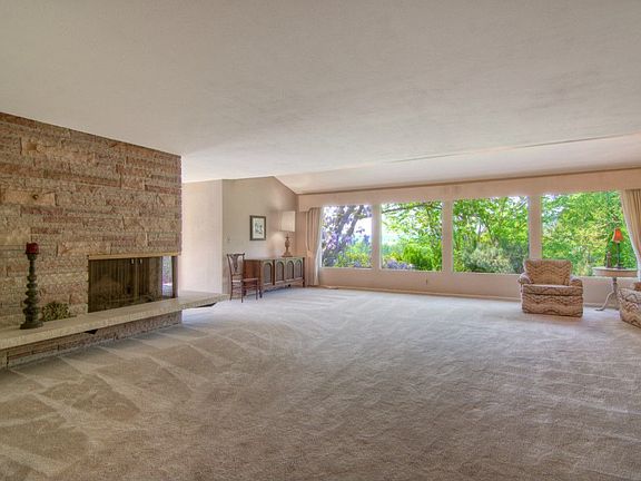 Huge living room area with wood buring fireplace and plenty of light.