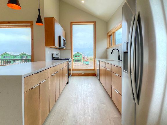 Full kitchen with to-floor window