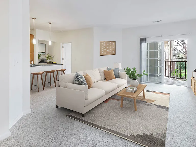 Carpeted Living Room with Balcony