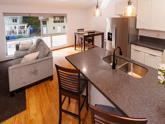 Open floor plan with updated kitchen and stainless steel refrigerator and dishwasher