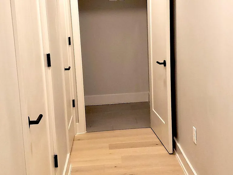 The hall that leads to the laundry room, the half bath and the entry closet.