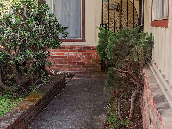 Front door with security gate running across the breezeway.
