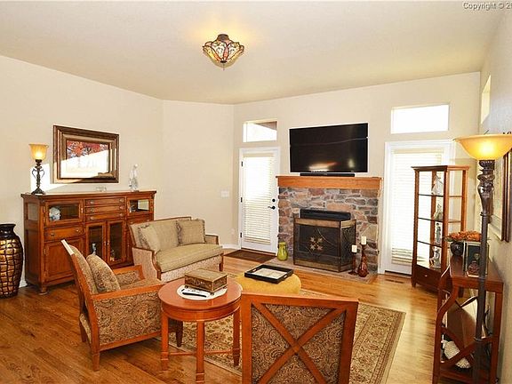 Living room has gas fireplace and walkout to patio.