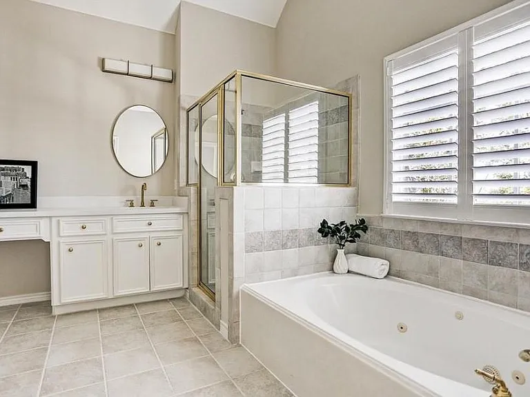 Master bathroom with double sinks, white quartz counter tops and fixtures gives this bathroom a glamorous update.