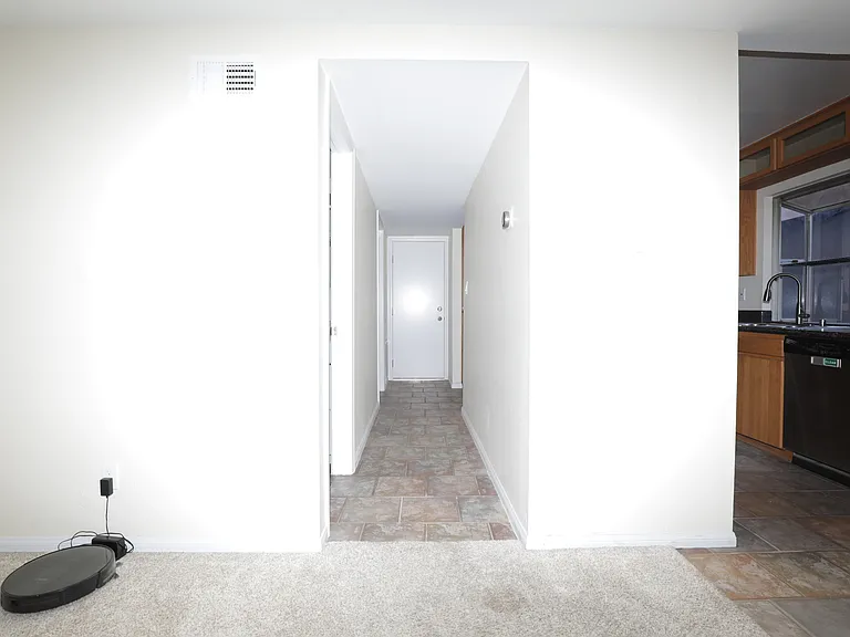 Hallway access to powder room, laundry room and garage