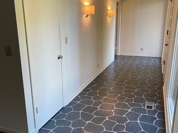 This is just the other view of the entry foyer. It leads into a large living room and dining area combination with the beautiful stone fireplace dividing the area. The carpet was installed new before the previous renter and there haven't been any pets o