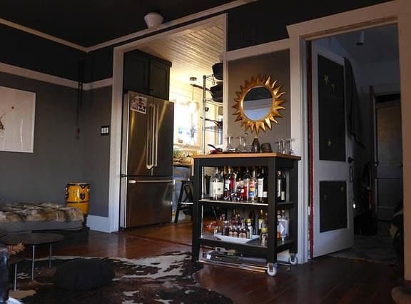 the newly painted living room is open to the kitchen