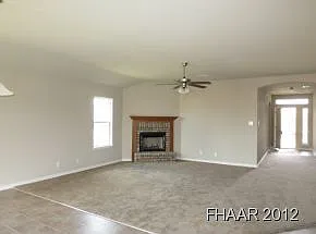 Spacious living room with brick fireplace & ceiling fan/light