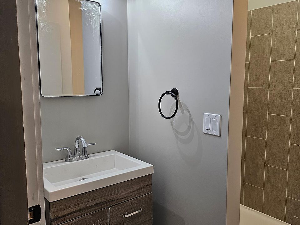 Single vanity with storage and shower.