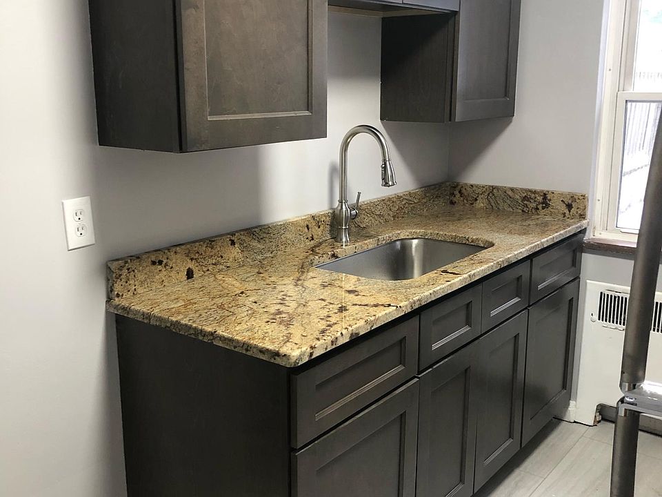 New kitchen cabinets, granite counter, sink, faucet, and flooring.