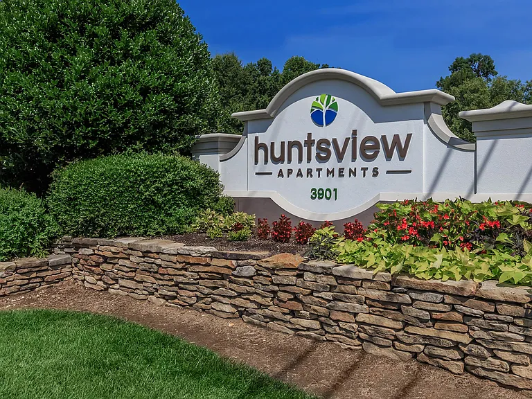 Huntsview Apartments Entrance Sign surrounded by Beautiful Landscaping