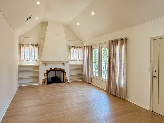 Living room with cathedral ceiling and original vintage fireplace
