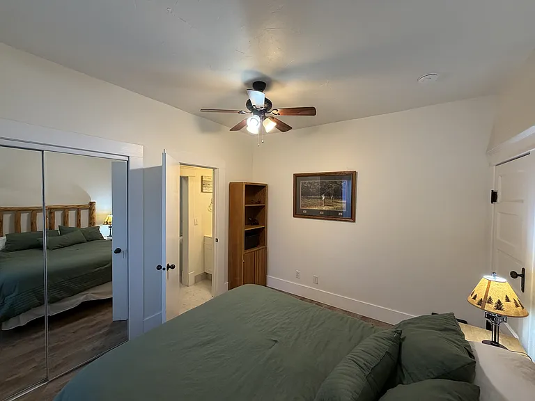 The primary bedroom suite features a queen-sized bed and bathroom with a tile shower.