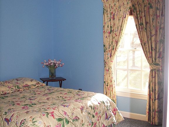 The secondary bedroom overlooks the front yard.