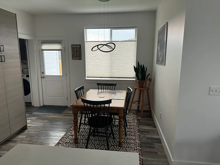 Dining area next to the kitchen, back door, and a doorway to the laundry area, powder room, and the garage
