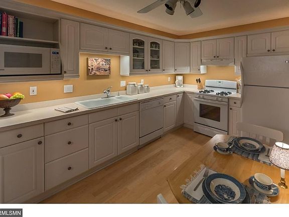 The Natural Maple hardwood floor, xenon under-cabinet lights, crown moulding and rope lighting atop the cabinets all contribute to the rich, warm look of this spacious eat-in kitchen.