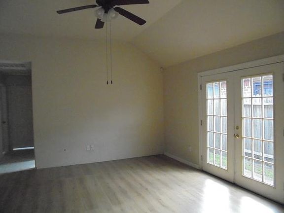 Spacious den with high ceiling and ceiling fan!