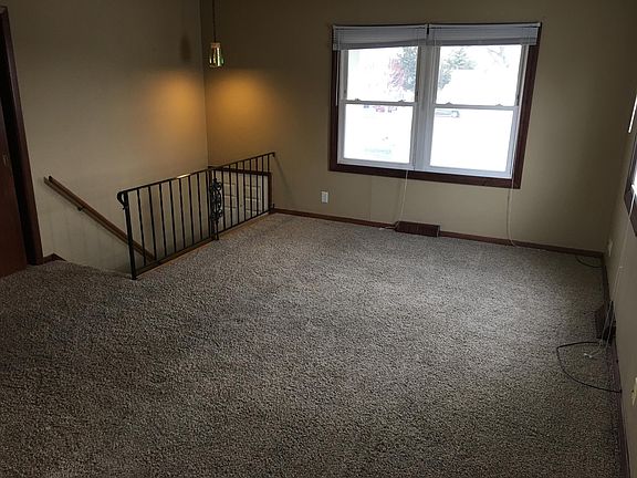 Big living room with plenty of natural light and new carpet.