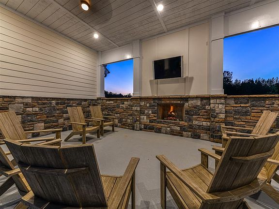 Cozy outdoor lounge with fireplace and TV