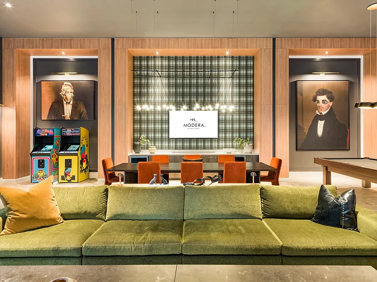 A thoughtfully designed media room featuring layered seating, warm wood paneling, and integrated technology for comfortable group viewing and shared experiences.
