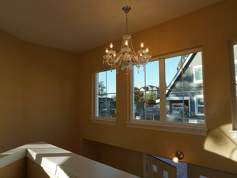 Two story high ceiling entry way with double doors .