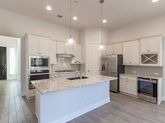 open concept kitchen/ dining/ living area - beverage fridge at right