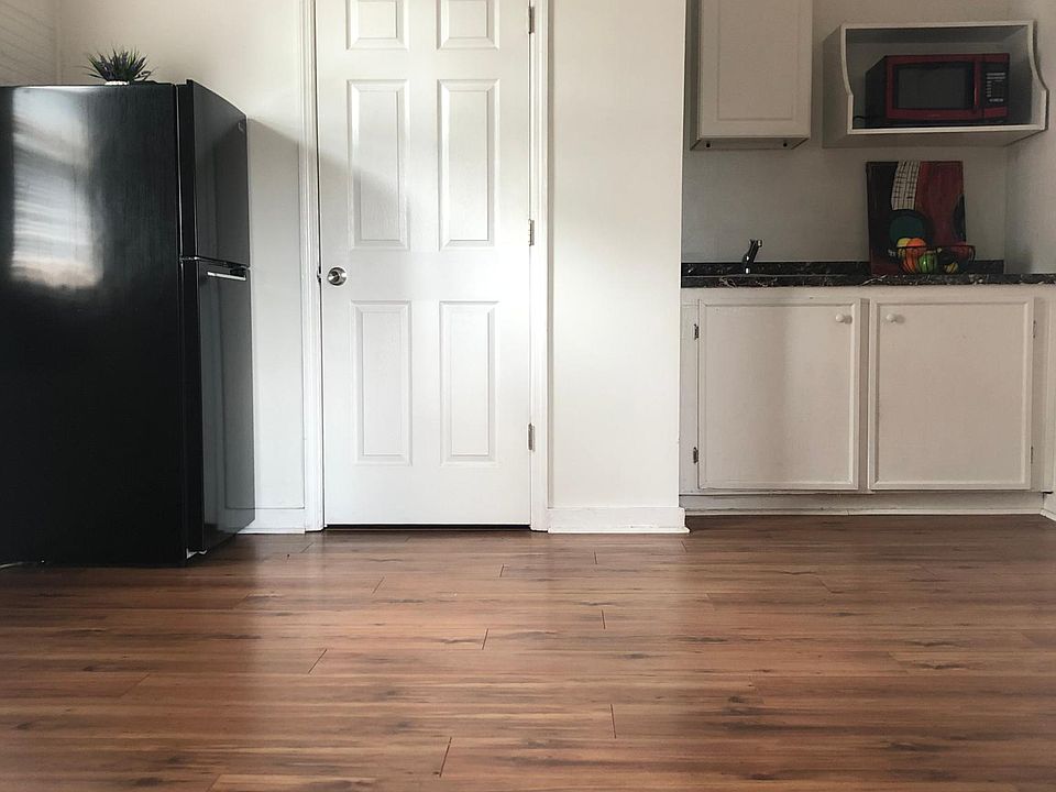 Living/dining room area with kitchenette.