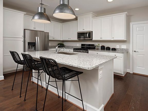 Model Representation - Stunning Kitchen with White Cabinetry and Stainless Steel Appliances