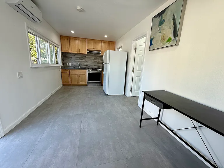 Perfectly designed living area (foreground) and kitchen (background).