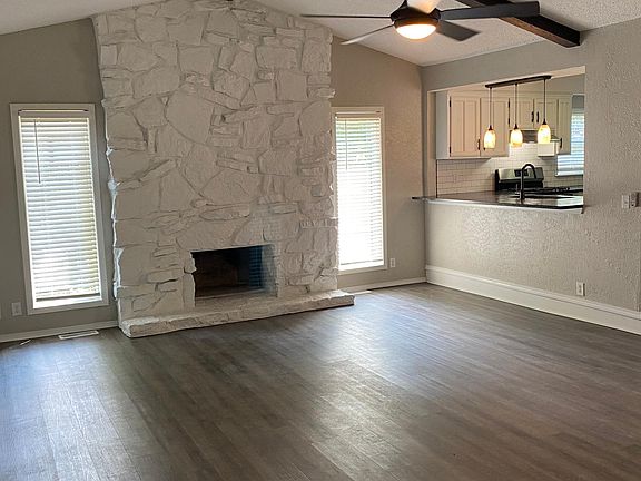 Kitchen is open to the living room. Granite overhang makes the perfect spot for barstools.