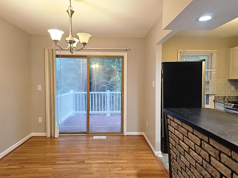 Dining area with deck entrance, breakfast bar and fully remodeled kitchen
