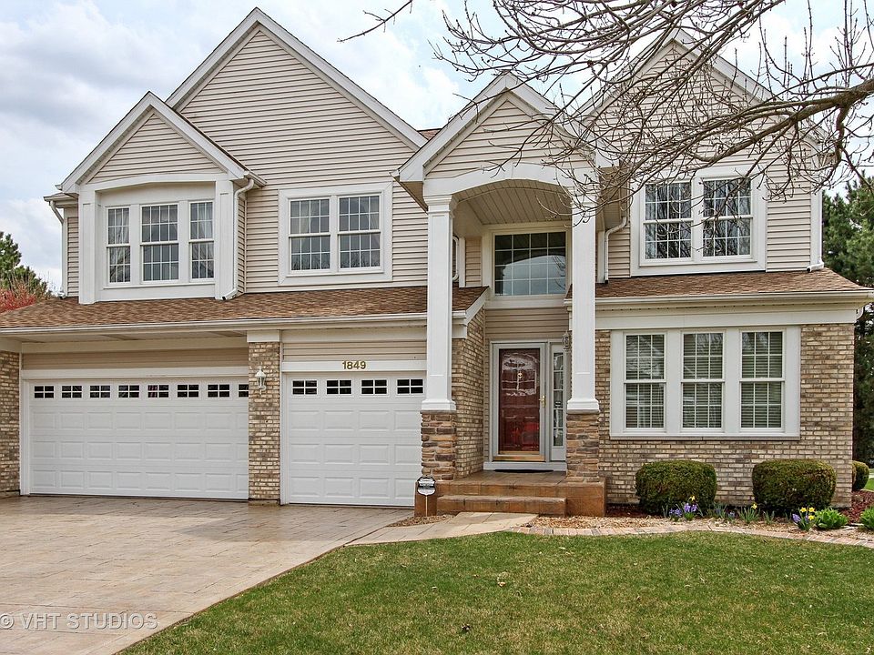 Exterior with stamped concrete driveway & walkway. New garage doors; great curb appeal