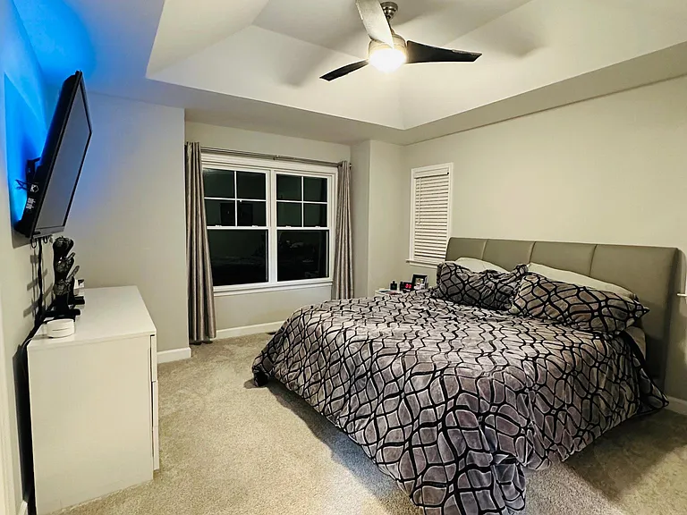 master bedroom with recessed ceiling