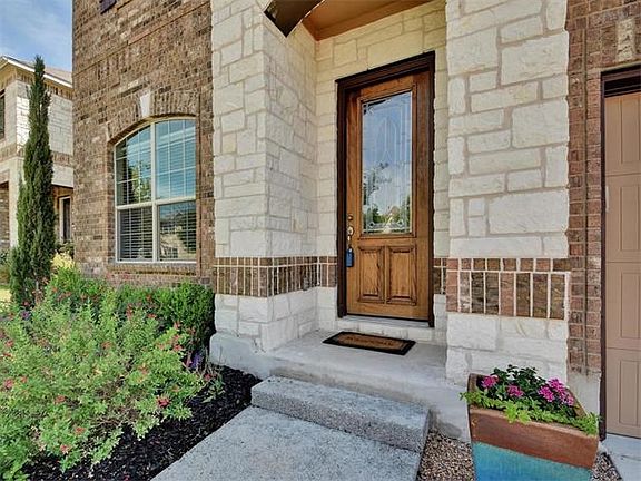 Brick and stone blends beautifully to highlight the different architectural elements of this home