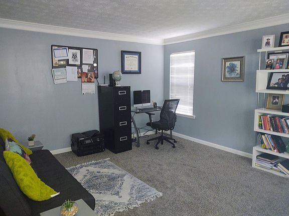 Spacious office with room for two desks and a lounge area.