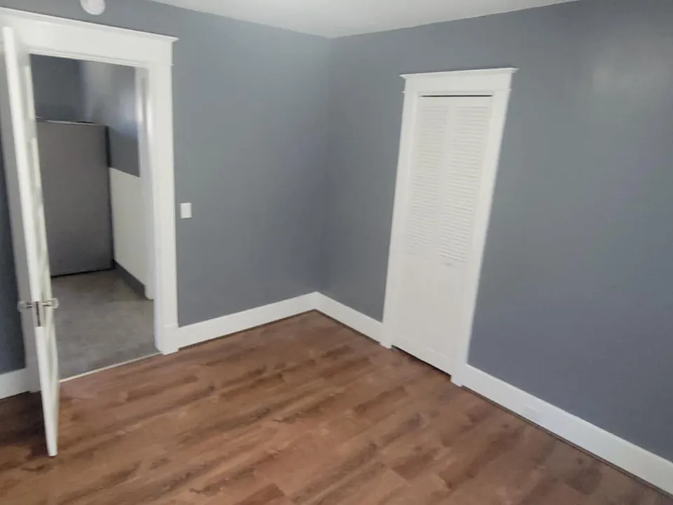 1st bedroom (12x11) facing kitchen with closet door