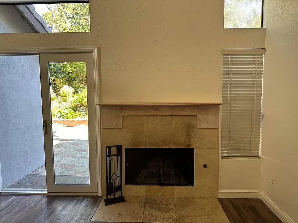 Living Room with Gas Burning Fireplace. French Doore leading top Backyard Patio