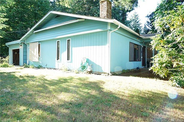 Corner picture showing front and side of house.  Garage is attached with door leading into the hallway.