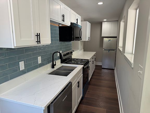 Kitchen with all new stainless steel appliances, including microwave and dishwasher