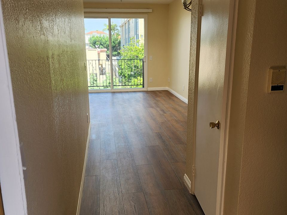 Apt#209 Front Entryway with View of Living Room Skylight and Patio/Balcony