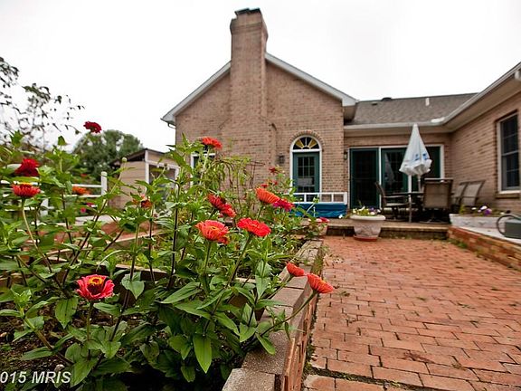 Spacious Brick Patio & Raised Flower Beds
